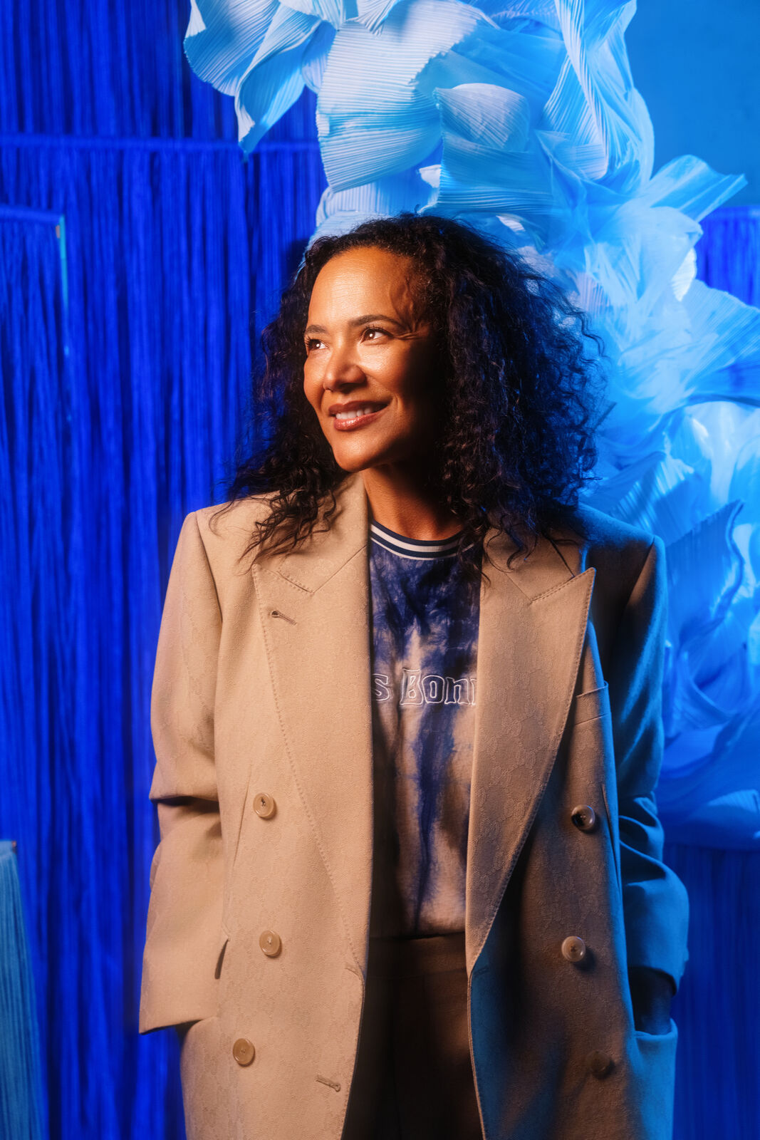 A guest in a yellow knit dress inside the blue paper installation at MOCAD