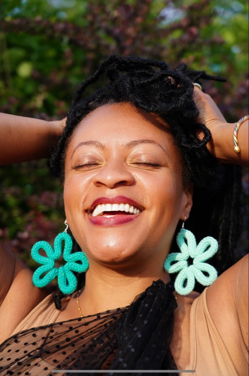 Woman laughing in teal and mint knit flower earrings